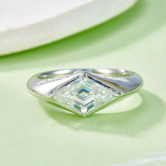 Silver ring with a diamond on a light green background